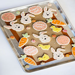 An array of different cookies on a baking sheet.