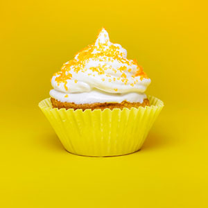 A lemon-flavored cupcake with vanilla icing on top.